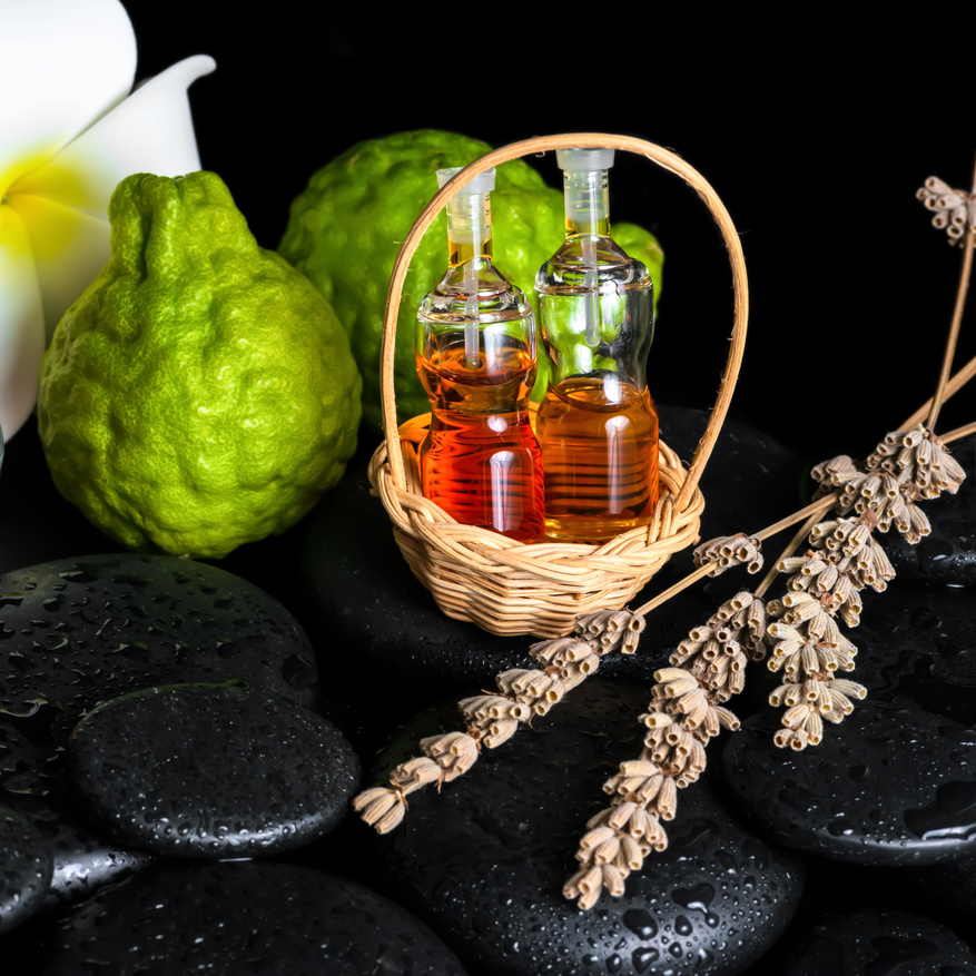 Aromatic spa concept of bottles essential oil, bergamot fruits,